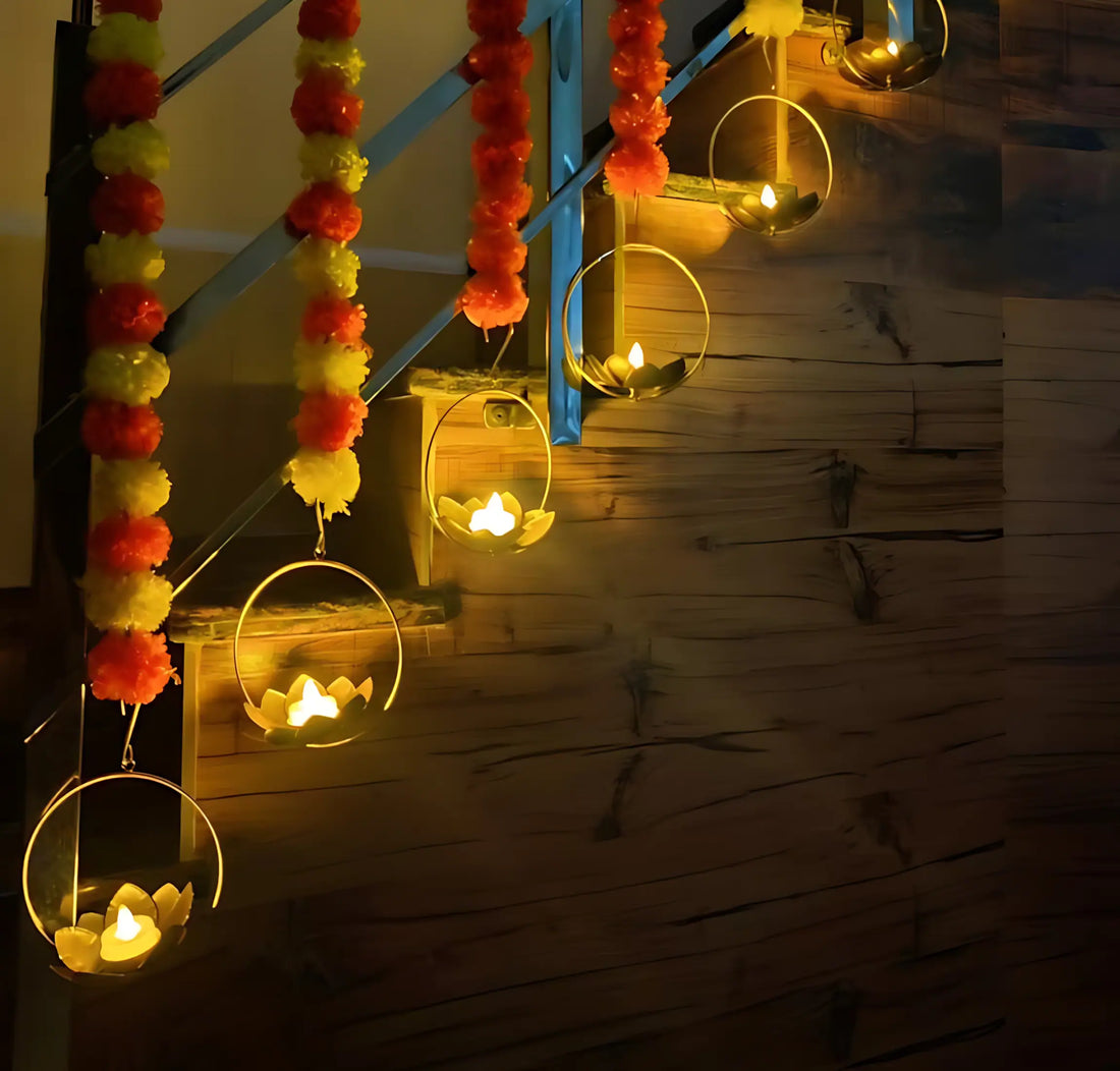 Glowing LED tea light candles in lotus-shaped holders, hanging on a wooden staircase alongside decorative garlands.